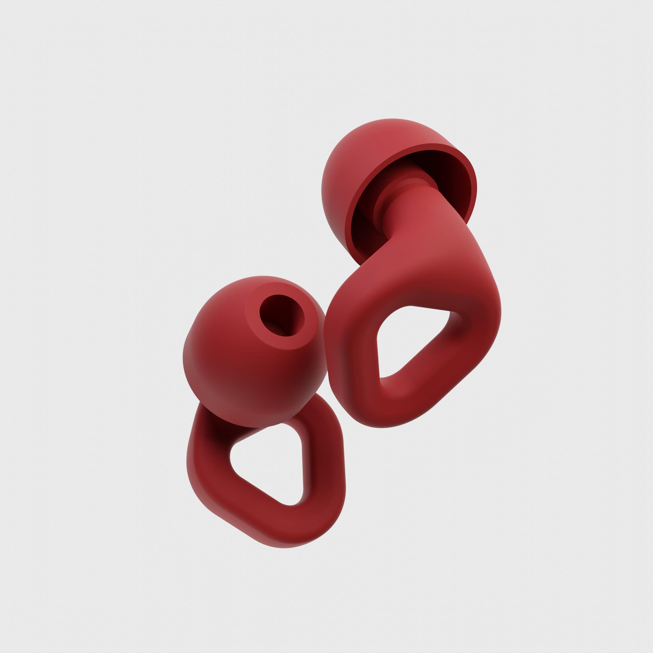 Close-up of Zenz Unwind red silicone earplugs showcasing their ergonomic design and noise-canceling features