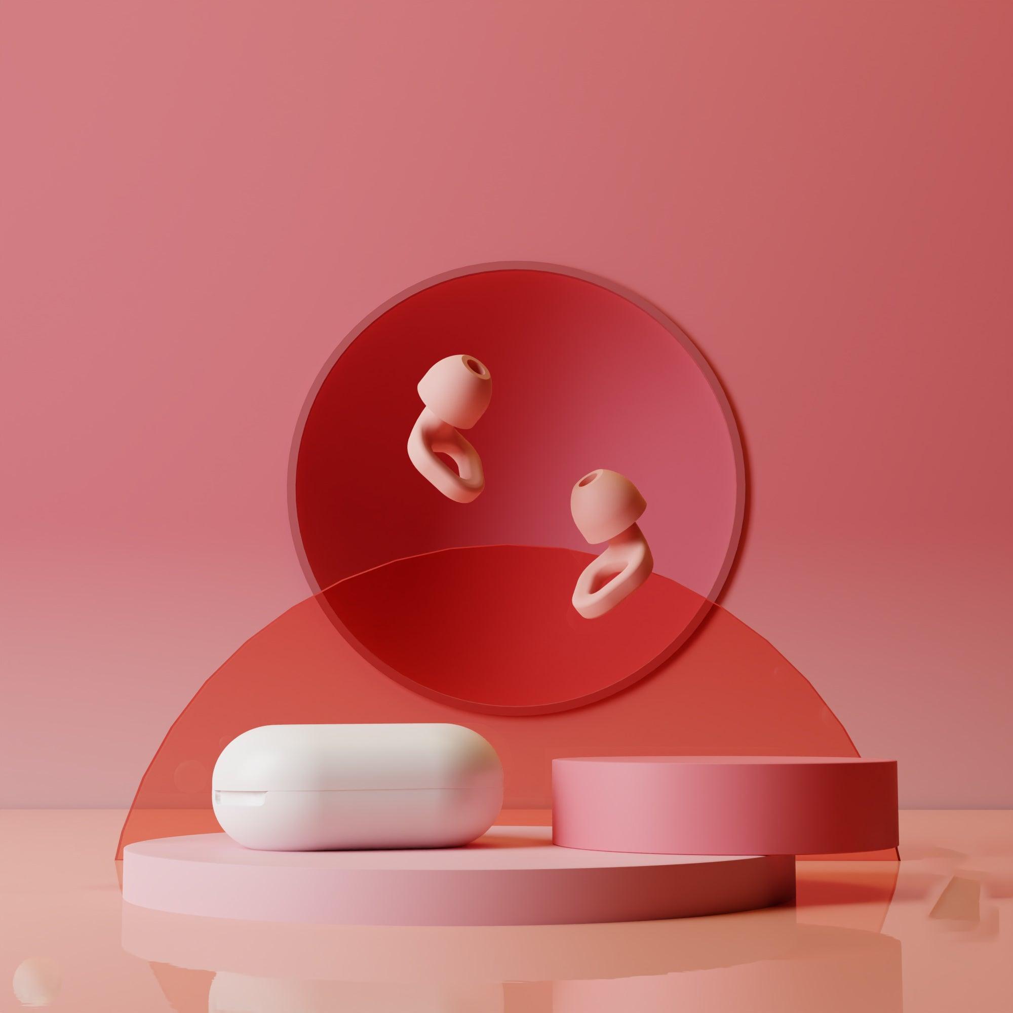 Zenz Unwind pink earplugs floating in a soft pink and white environment, highlighting their stylish design and portability