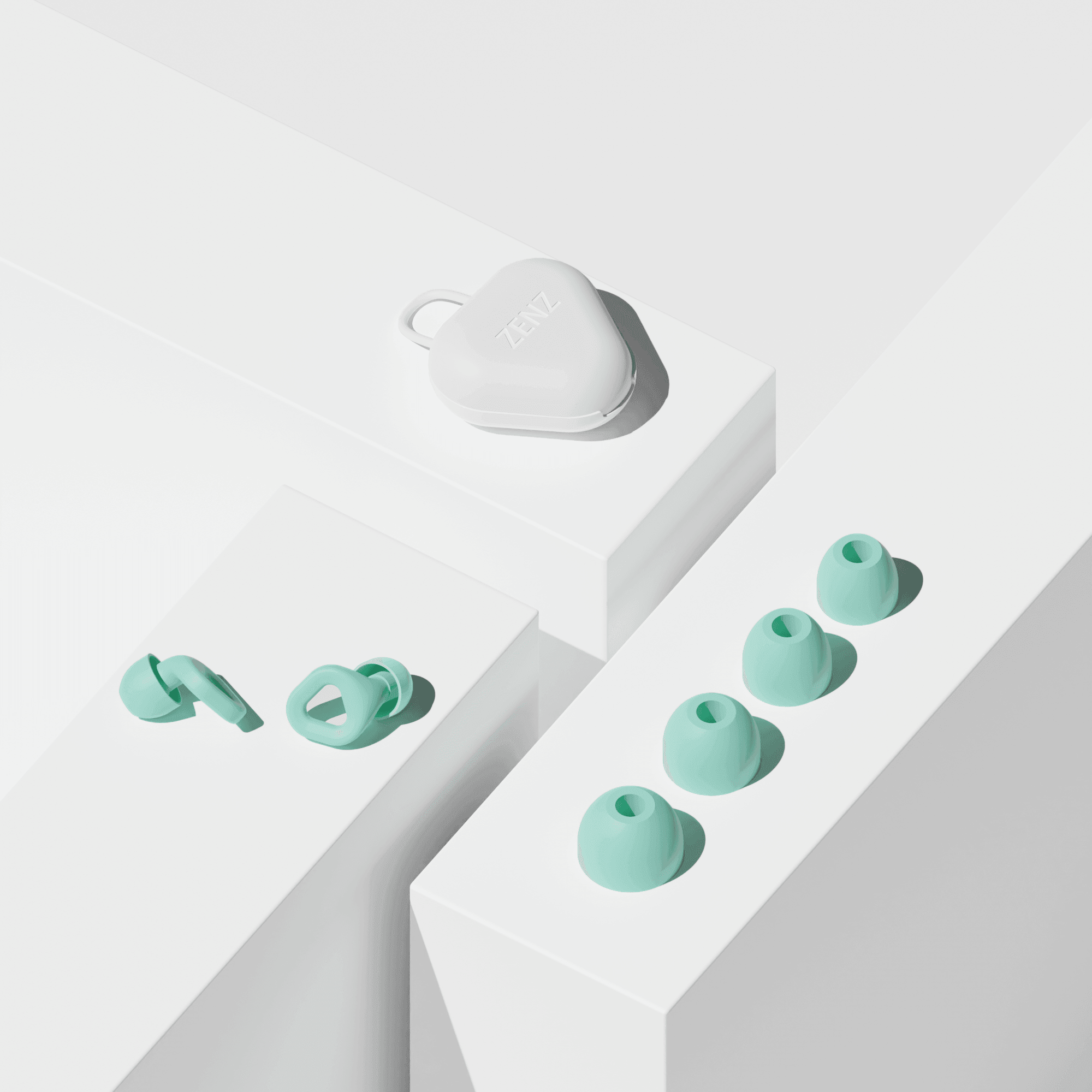 Zenz Unwind mint green earplugs displayed with extra tips on minimalist white pedestals, highlighting their sleek design and customisable fit