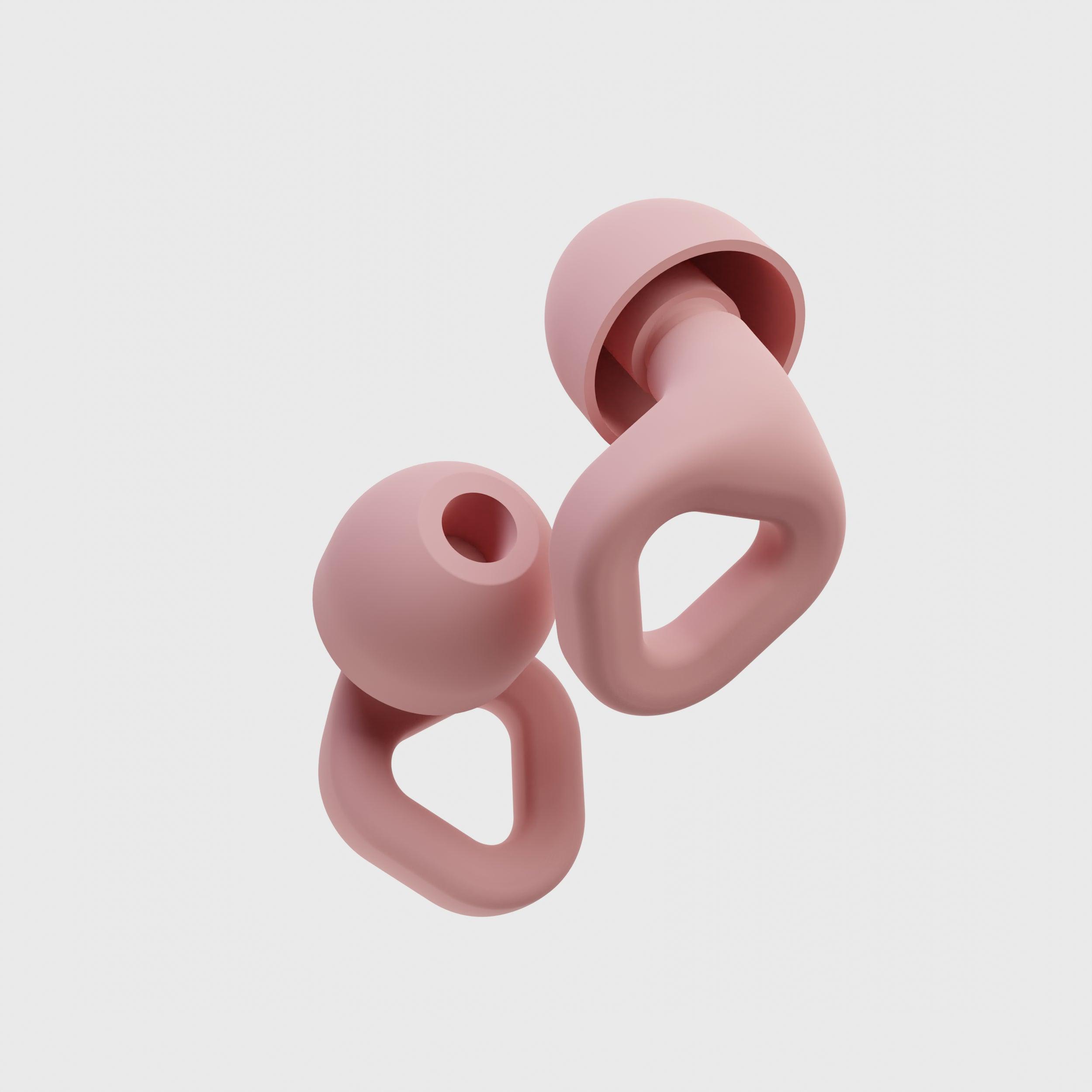 Close-up of Zenz Unwind pink silicone earplugs showcasing their ergonomic design and superior noise-canceling features